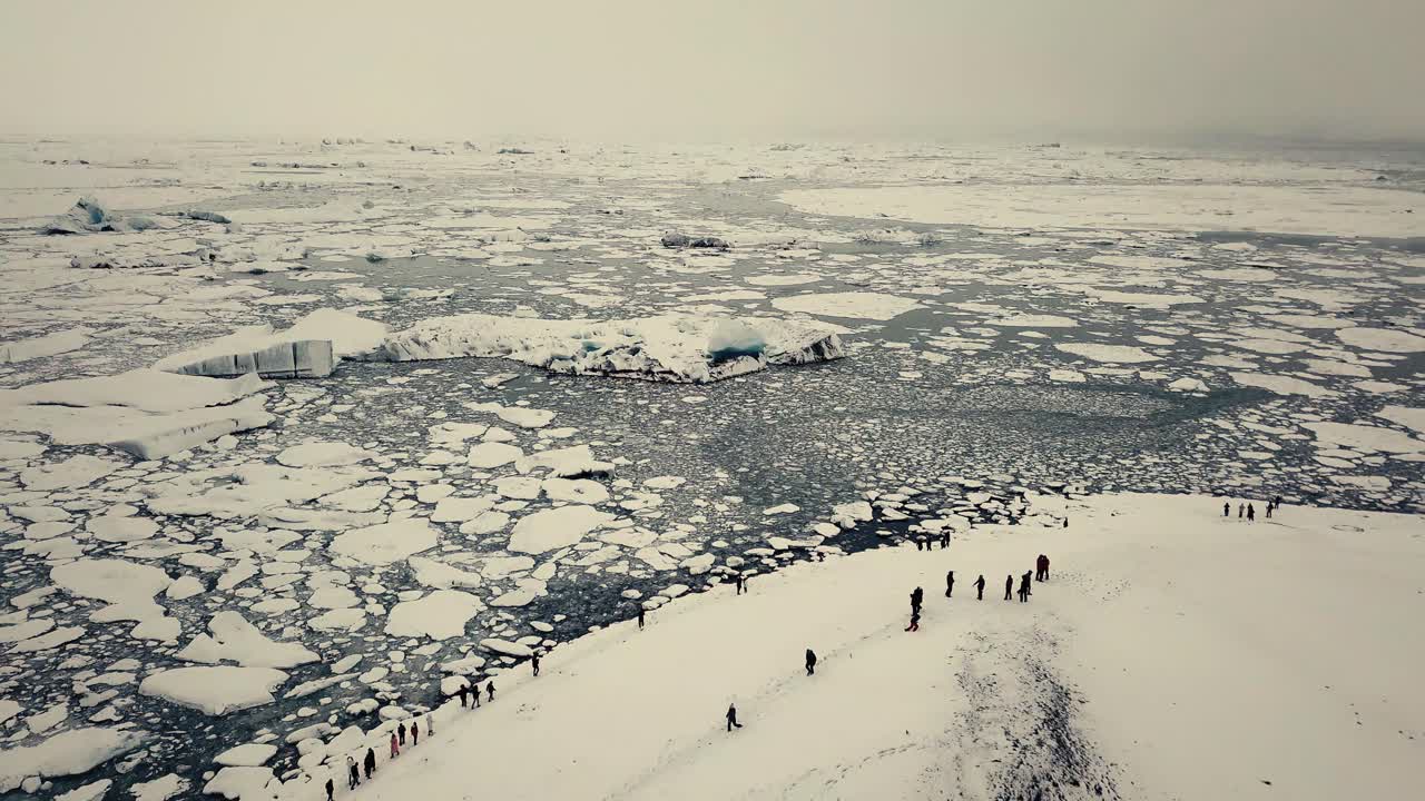 Glacier tongue in Iceland filmed by drone with different cinematic movements, showing a cloudy, dramatic concept in wintery conditions