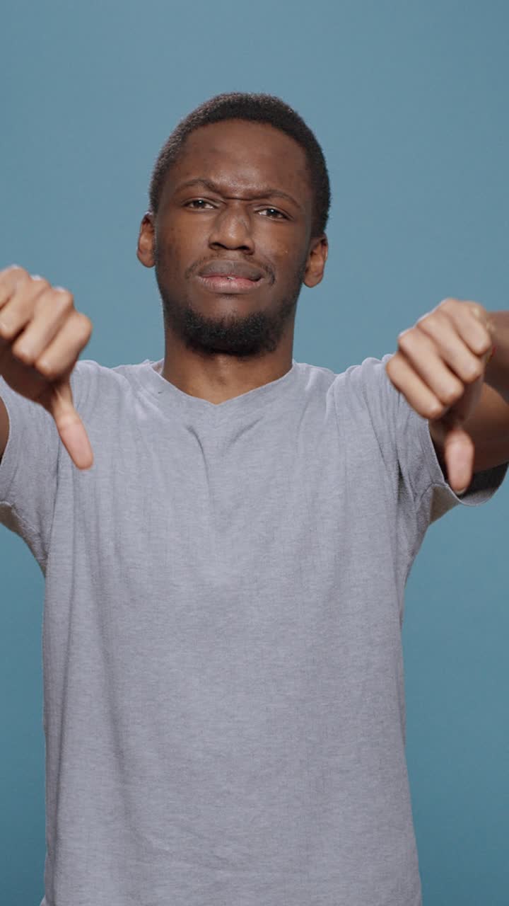 Man giving thumbs down gesture