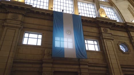 argentine flag displayed in railway hall hand held shot