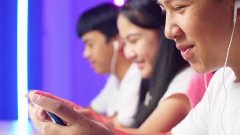 Close Up Team Of Asian Esport Gamers Playing In Competitive Video Games On A Cyber Games Tournament By Mobile Phone