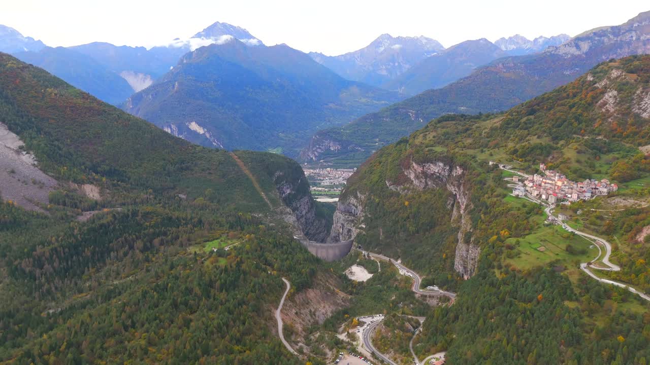 Aerial View of a Mountain Valley with a Dam and Village