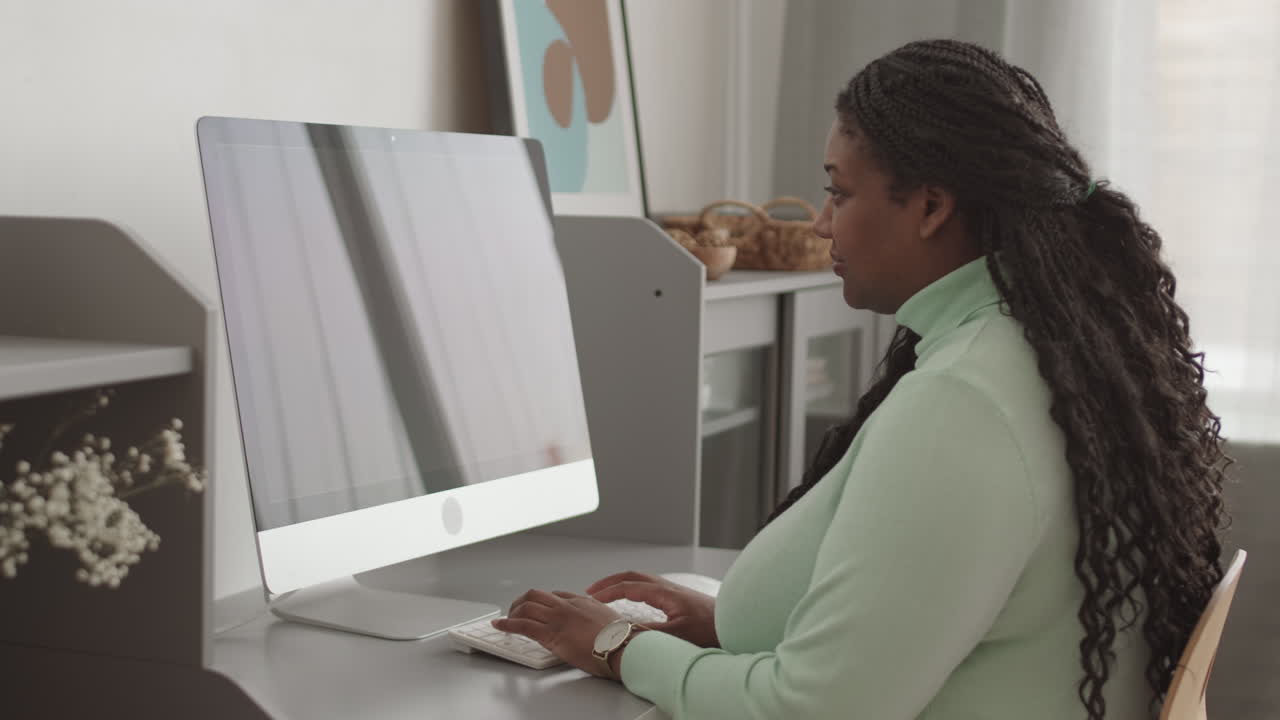 Young African Businesswoman Typing on Keyboard