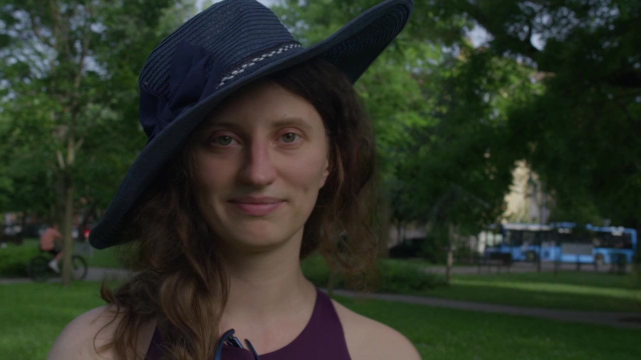 Beautiful young lady playing around with a blue hat