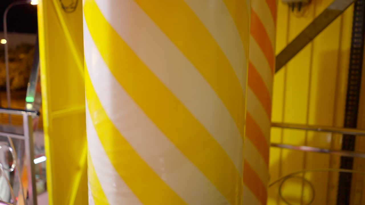 Striped Columns of a Night Amusement Park Ride