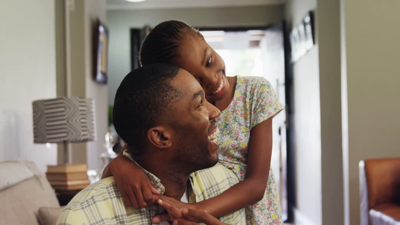 Daughter embracing her father in living room 4k