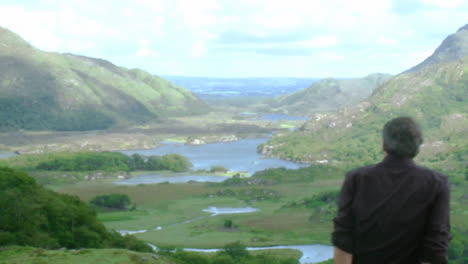 young man sitting on the top of a mountain