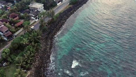 aerial drone flying over tropical beach along highway in sri lanka