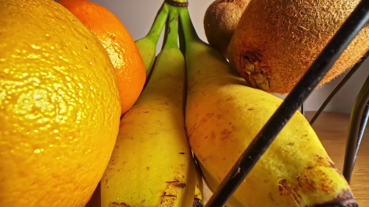 Exotic fruit basket close-up, yellow banana orange and kiwi sweet tropical flavour