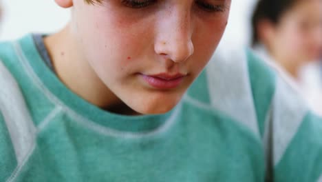 Schoolboy-working-on-electronic-project-in-classroom