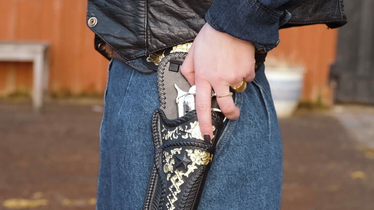 Cowgirl touching and pulling out gun