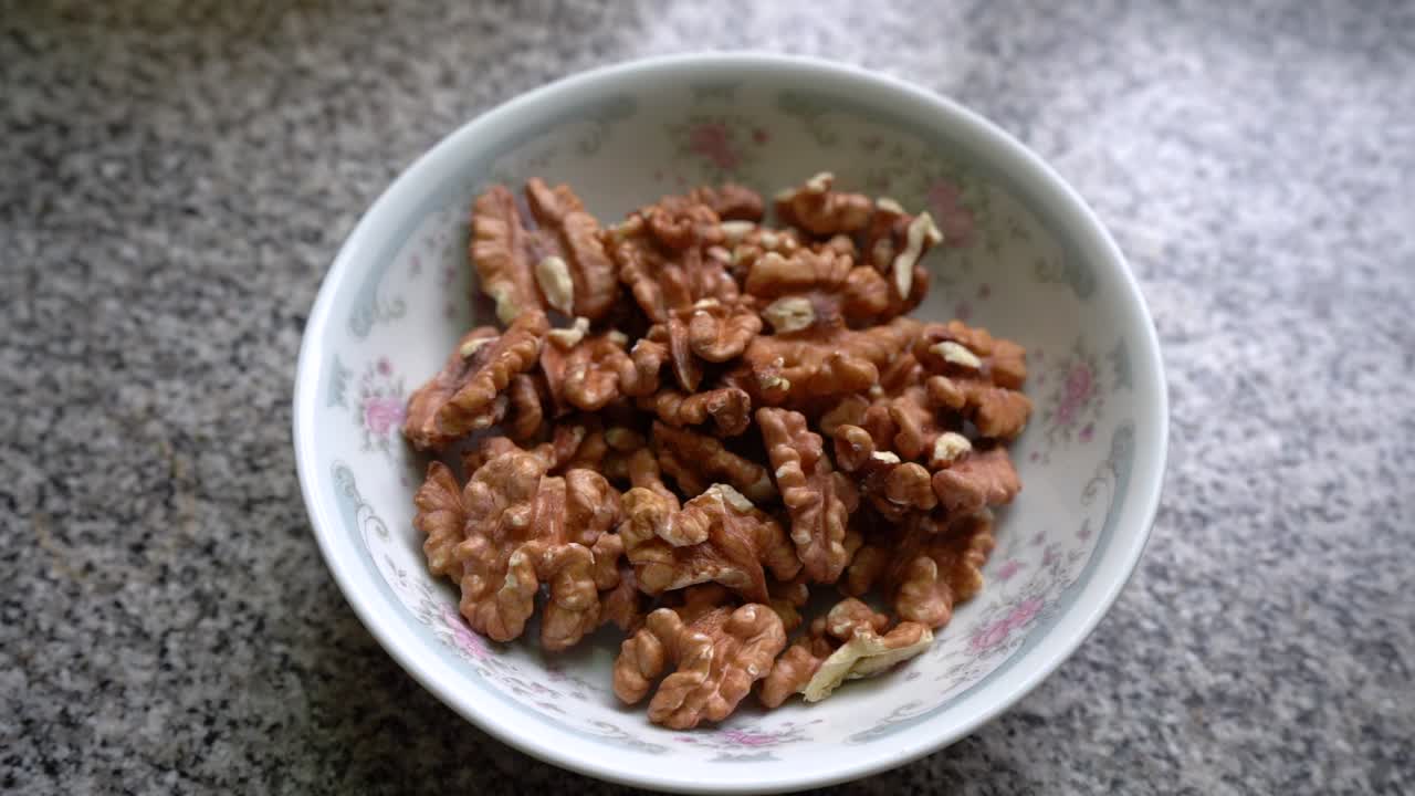 Peeled Walnuts In A Ceramic Bowl. - closeup