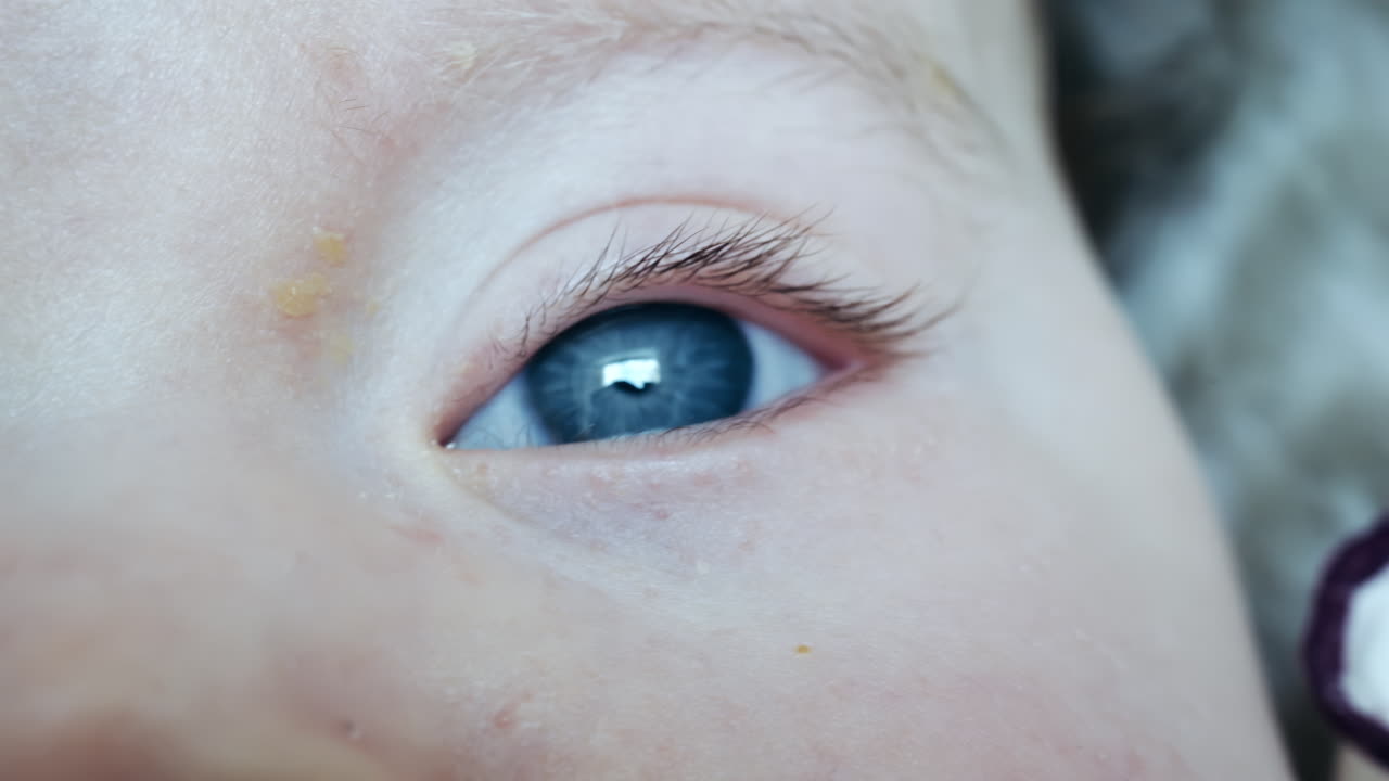 Extreme close up of a baby's face focusing on nose and eyes with soft lighting
