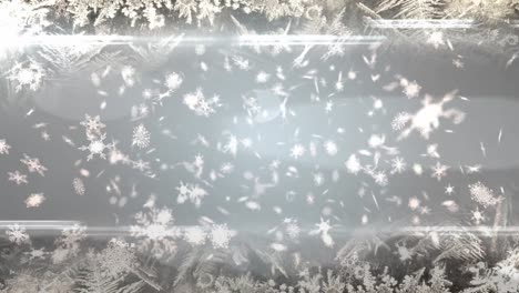 animation of christmas snow falling over christmas decorations on grey background