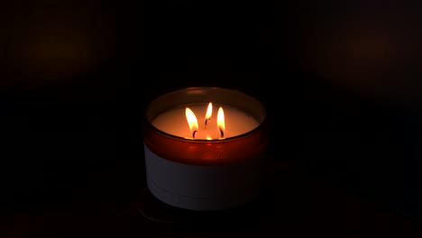 4k, slow mo, three candles burning with dark background
