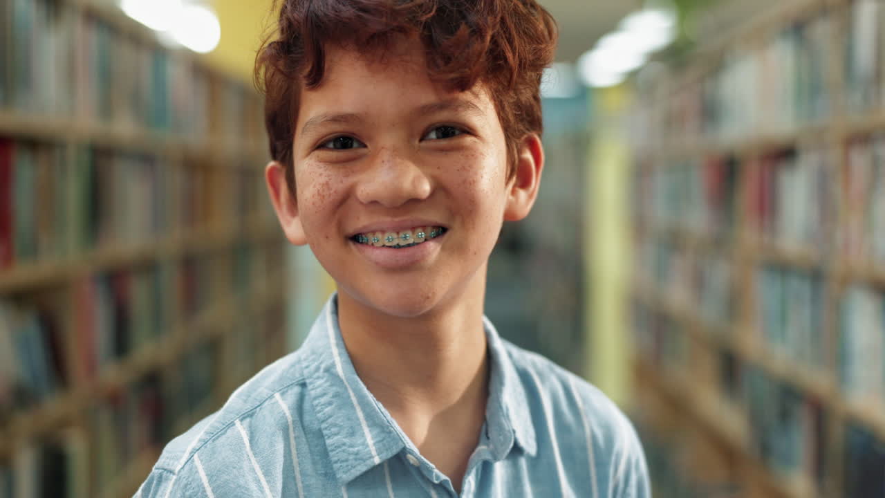 Teenage boy with braces in a library
