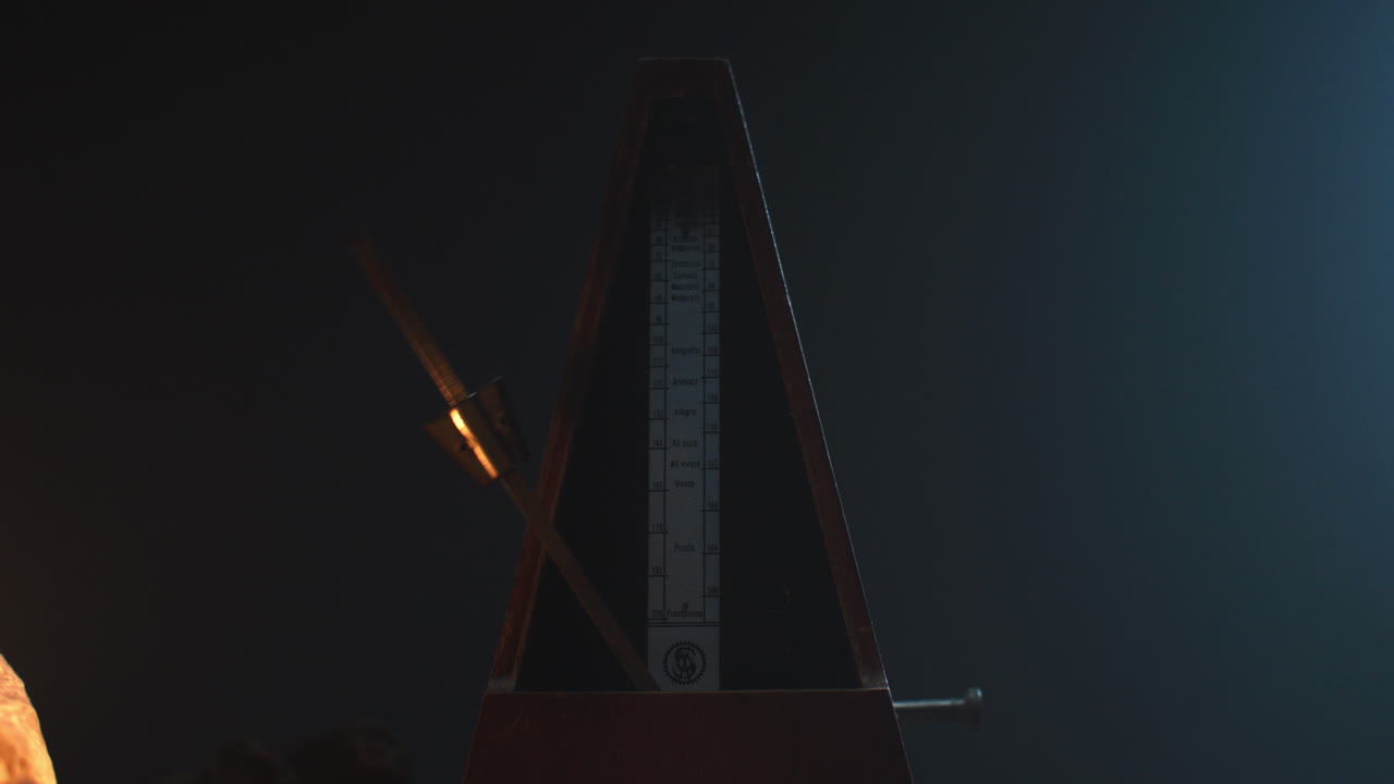 Metronome set the rythm in the dark, old room