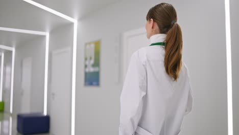 doctor walking in a modern hospital hallway