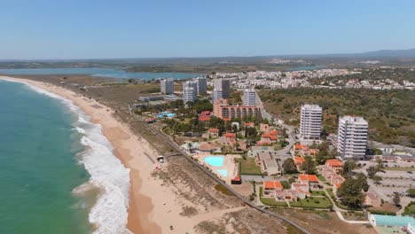 stunning coastline of portimao, luxury ocean view hotel high rises, aerial pullback