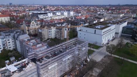 Building-crane-Great-aerial-top-view-flight-Berlin-City-Construction-work-on-house-with-crane