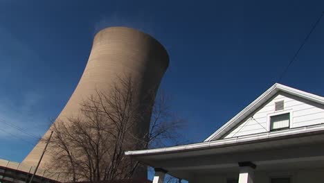 the roof of a residential home looks in close proximity to a nearby nuclear power plant