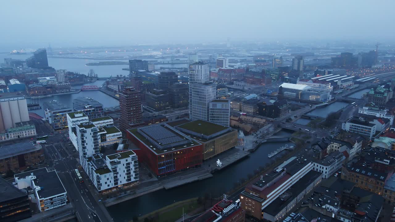 Beautiful aerial of Malmö on a fog covered morning. High rise apartment buildings and the Clarion Hotel can be seen in the Swedish city