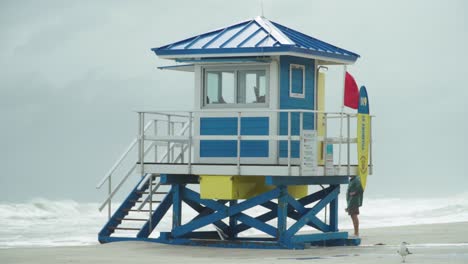 tropical storm, lifeguard house with red flag on