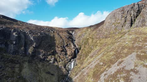 Drone pullback Mahon Falls Comeragh Mountains Waterford Ireland on a clear winter day