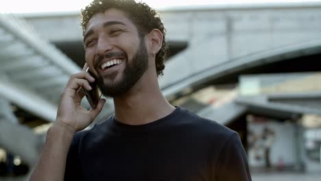 Front-view-of-bearded-man-talking-on-smartphone