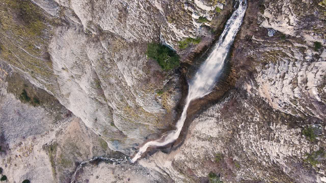 giro aéreo en cámara lenta vertical hacia abajo cerca de una cascada en tzoumerka, grecia