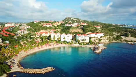 aerial orbit of the blue bay of curacao, dutch caribbean island, resort of golf on a sunny day