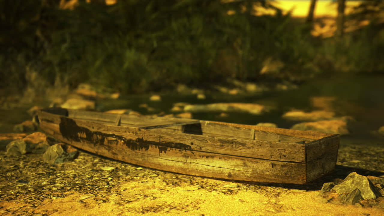 Wooden boat resting on the shore of a tranquil river during sunset