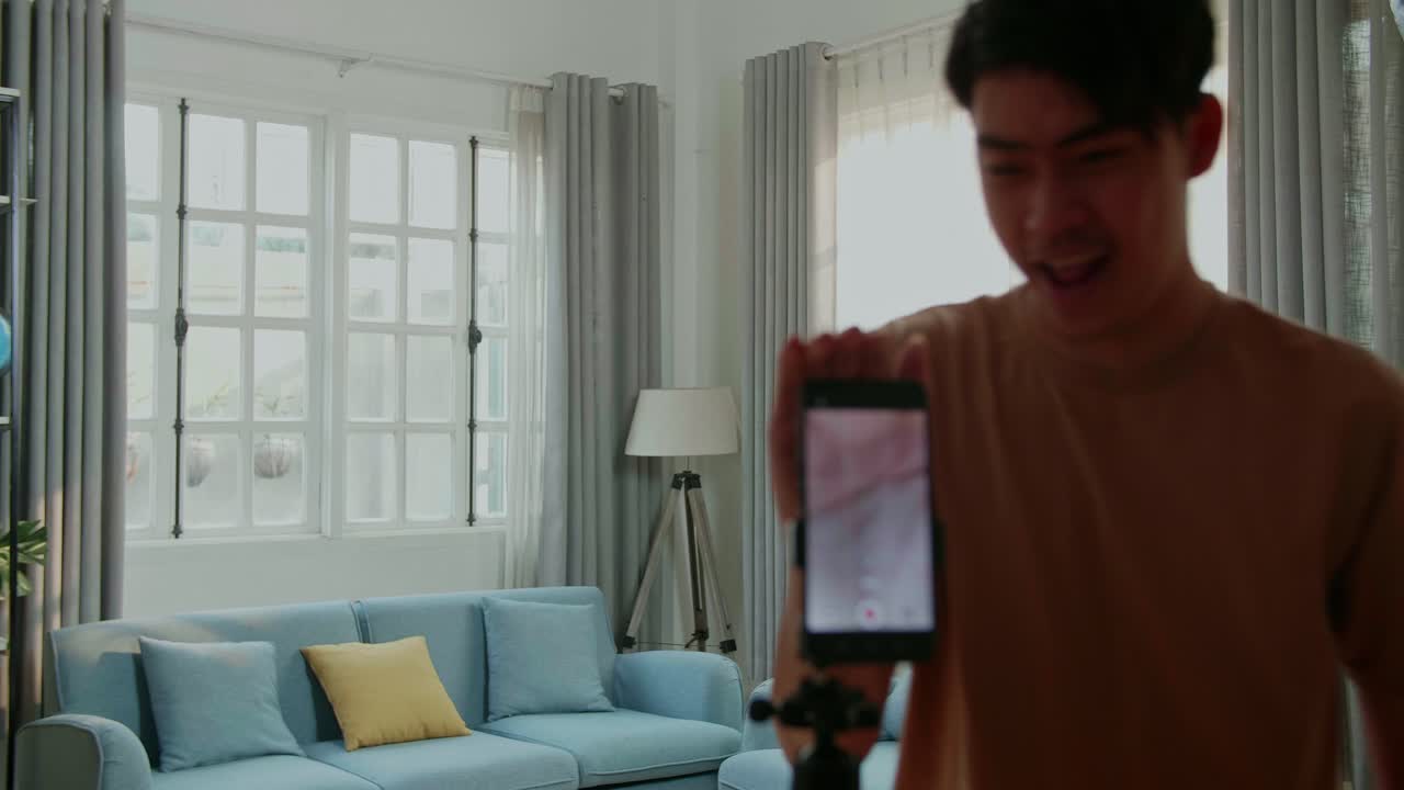 Young Man Recording a Dance Video at Home