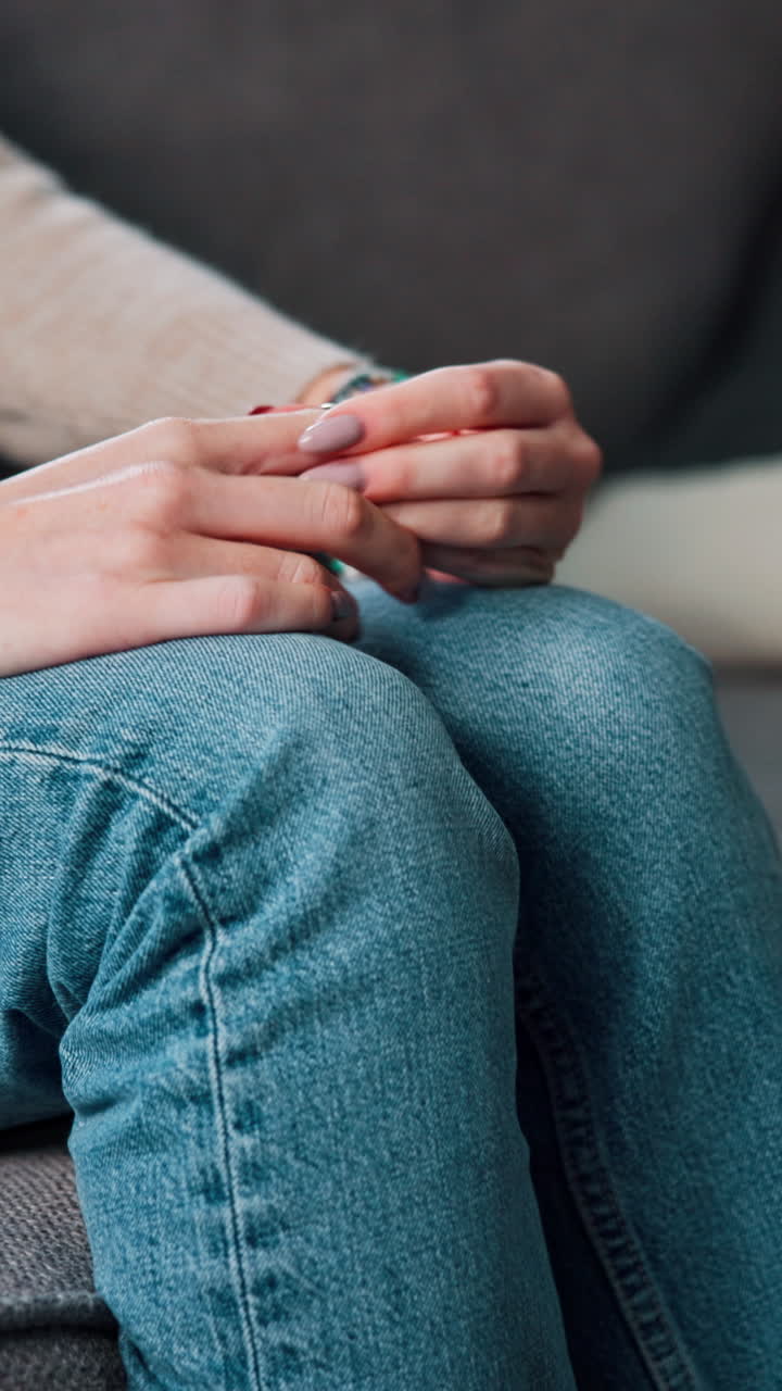 Close-up of a person's hands wearing jeans and a ring
