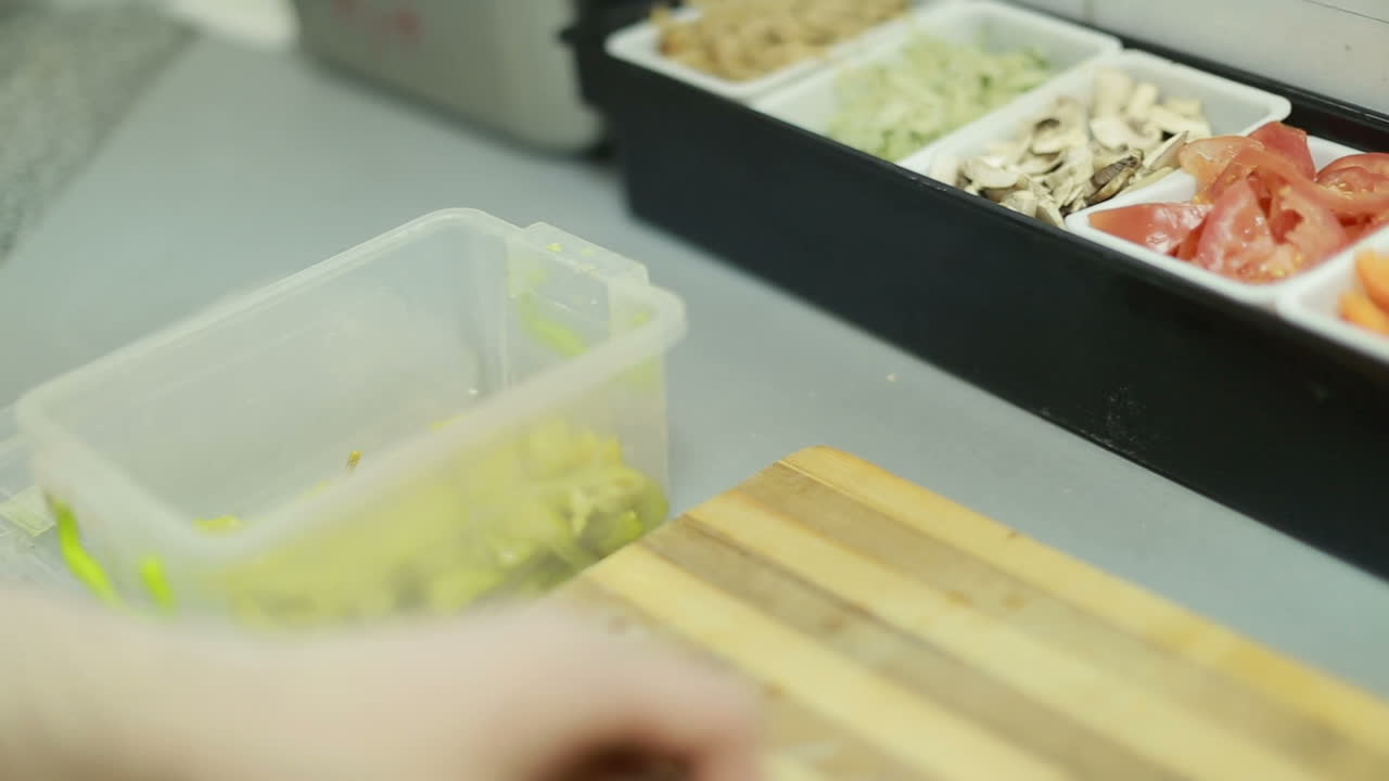 Chef Preparing Salad In Kitchen. Busy chef at work in the restaurant kitchen