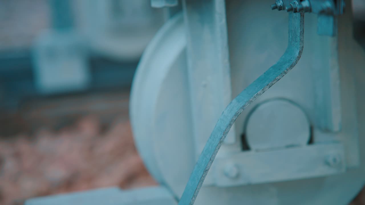 Worker inspects heavy machinery outdoors in winter with precision focus
