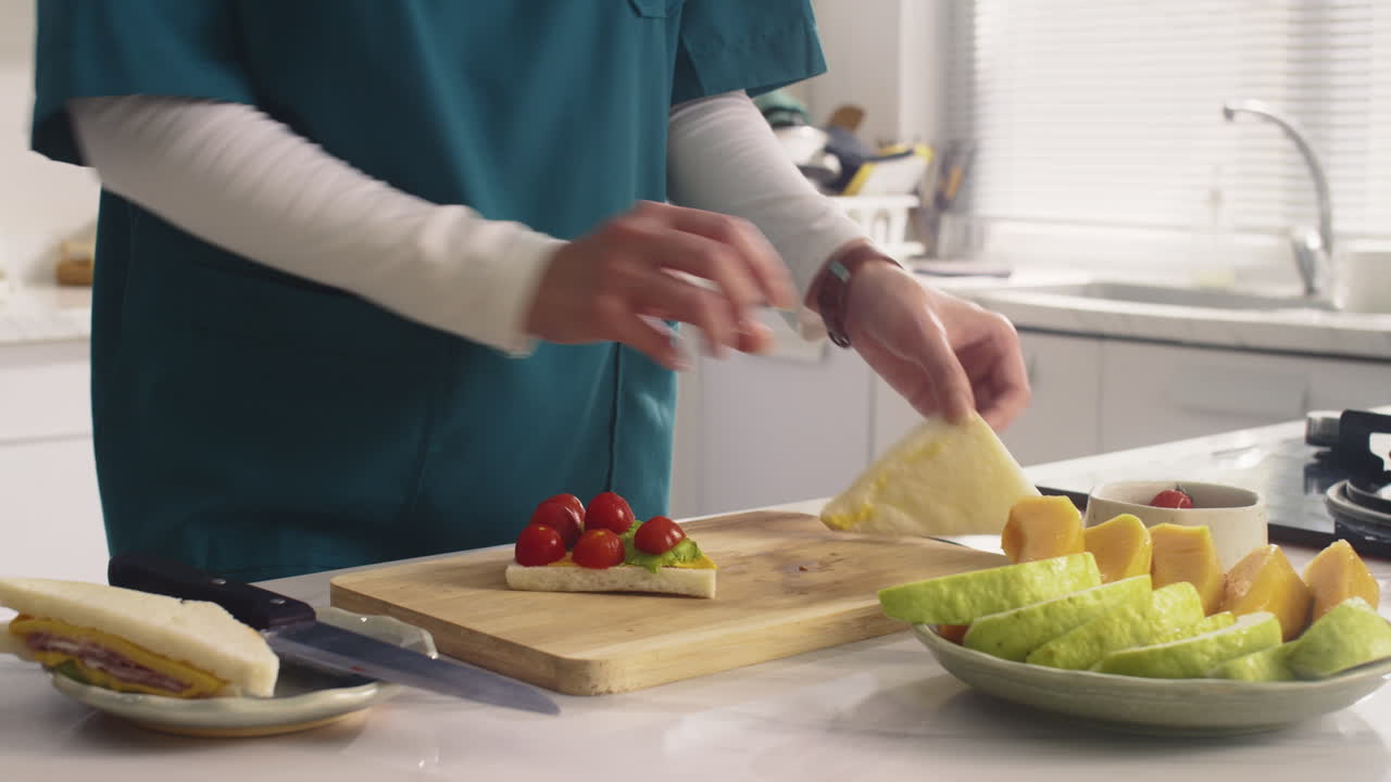 Unrecognizable Medical Worker Making Sandwich before Work