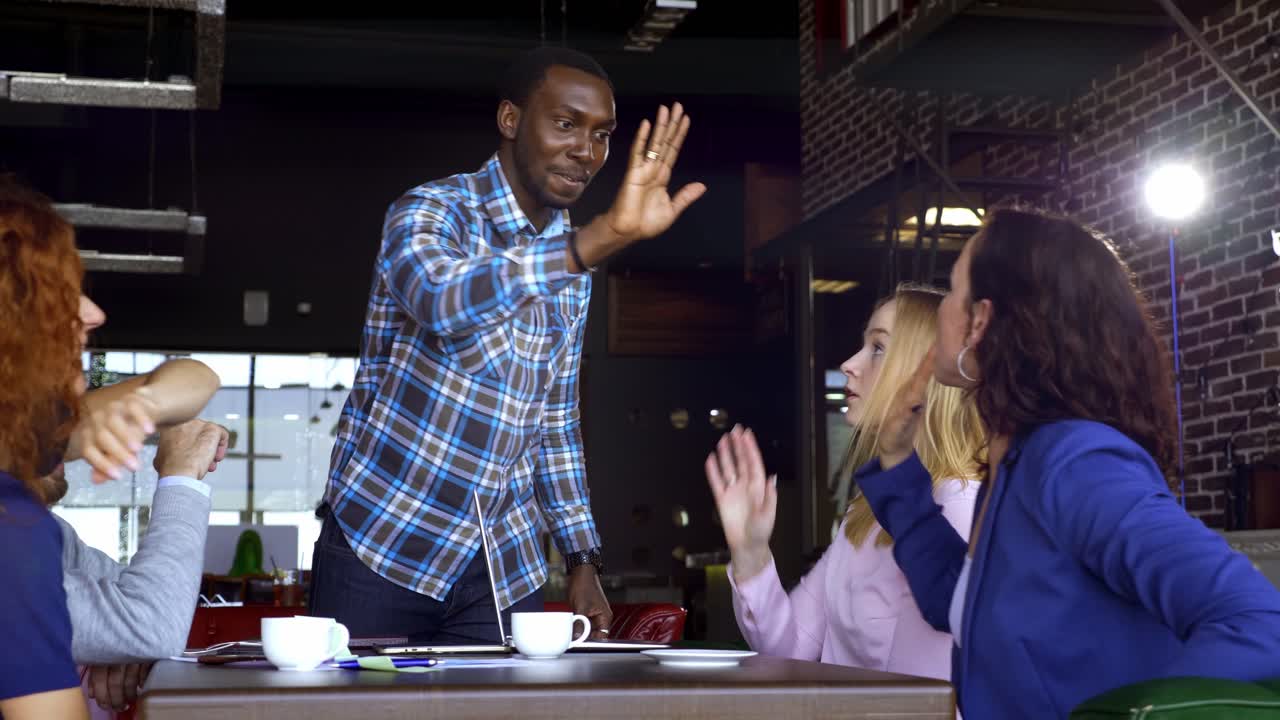 Team Celebrating Success in a Coffee Shop