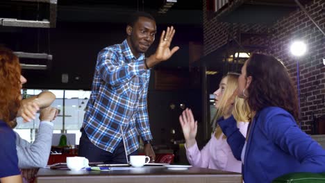 team celebrating success in a coffee shop