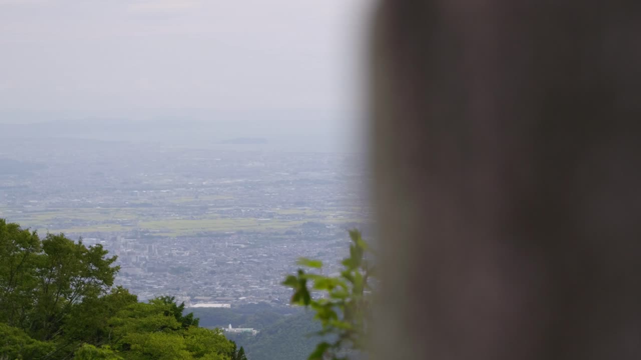 Perfect high above landscape reveal over Japanese countryside below