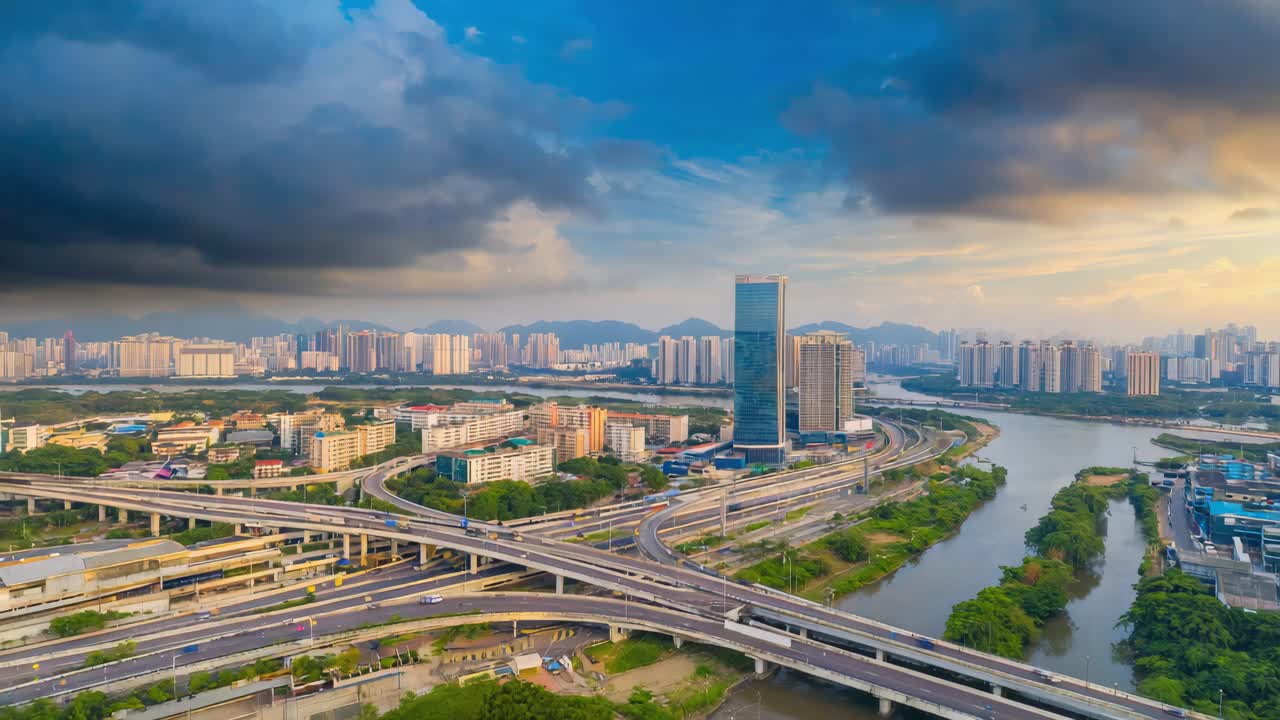 Aerial view of a modern city with complex highway interchanges and a river at dawn or dusk