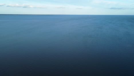 Sea-aerial-in-United-Kingdom,-Isle-of-Grain,-clouds-in-the-sky