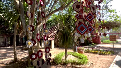 vibrant ornaments hanging from trees in sunlight