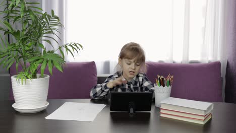 girl doing online homework using digital tablet computer. distance education