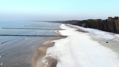 Aerial-shot-of-sandy-beach-in-Ustka-in-winter