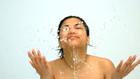 happy woman splashing water on her face