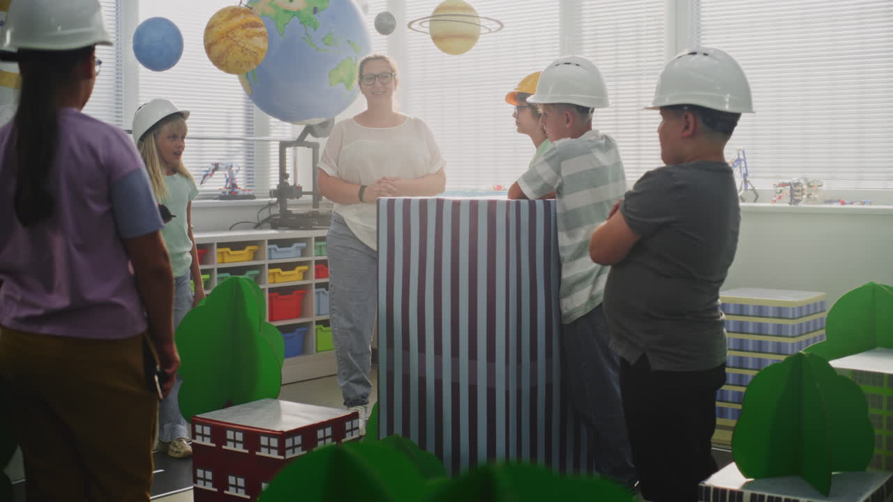 Smart Kids in Hardhats Discussing Urban Planning Elementary School Boy Giving Instructions