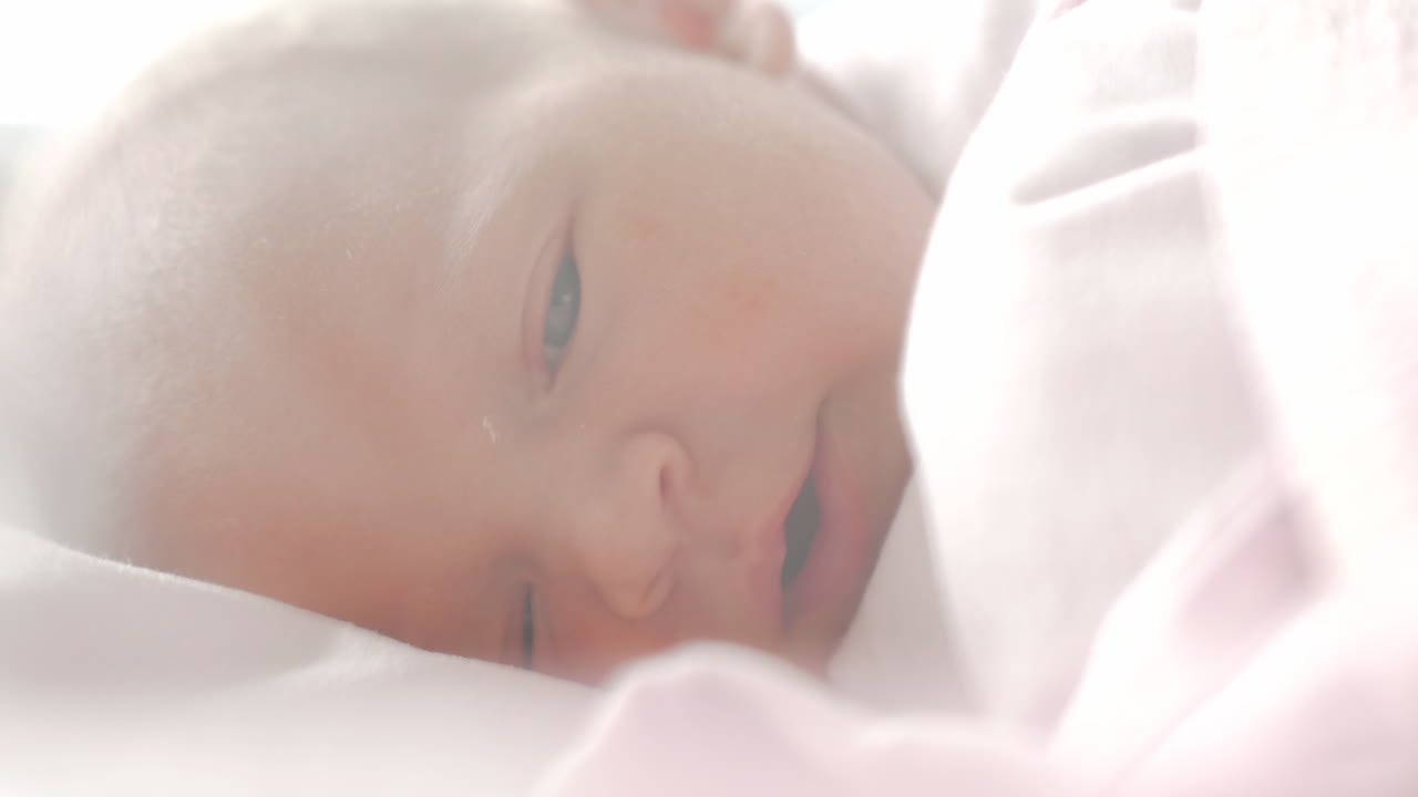 Neonato con gli occhi azzurri che si addormenta