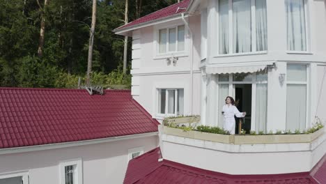 woman on balcony of a luxury home