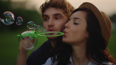 Couple-blowing-soap-bubbles