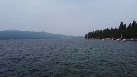 Drone-zoom-shot-from-a-low-angle-a-few-feet-above-the-water-at-Lake-Payette-in-Idaho